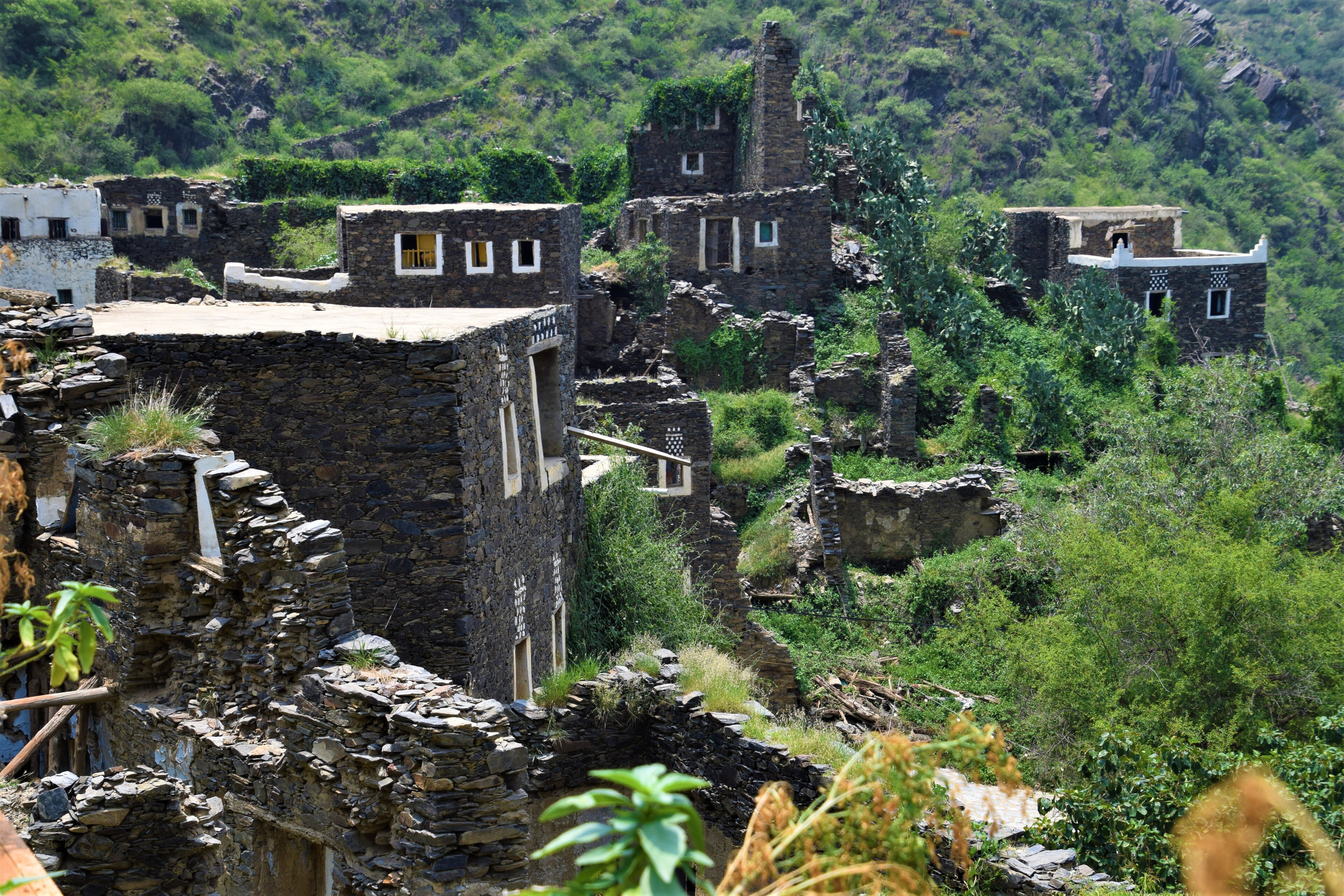 Stone houses of Rijal Almaa among green terraces